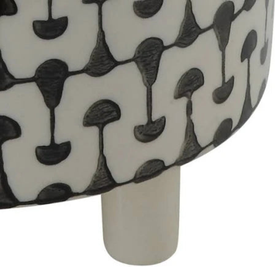 A black and white geometric patterned stoneware footed planter.